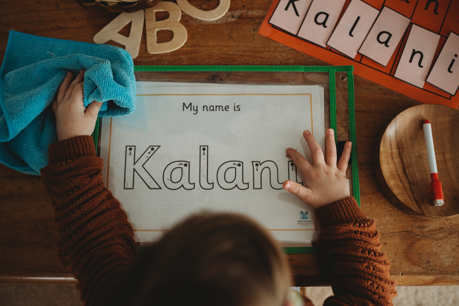 Kalani working on her name tracing sheet